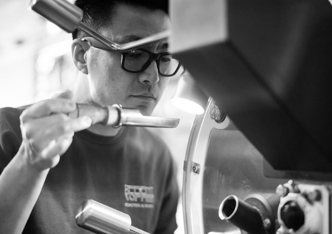 Owner of Regent coffee smelling the beans of a roast cycle with a focus on precision