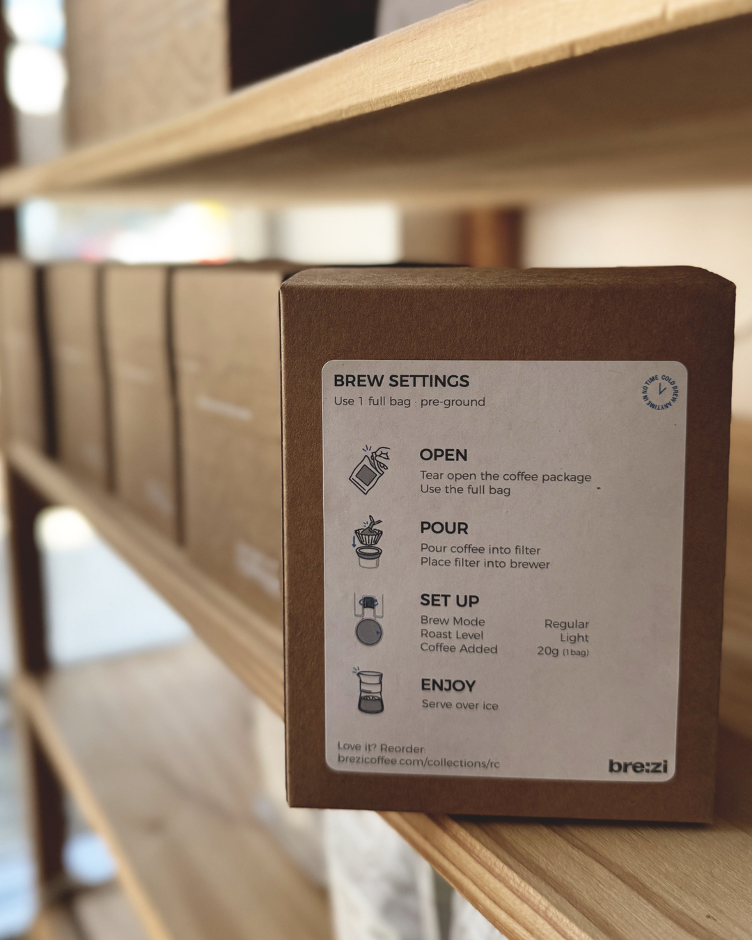 Brown coffee packaging with brew settings on a wooden shelf