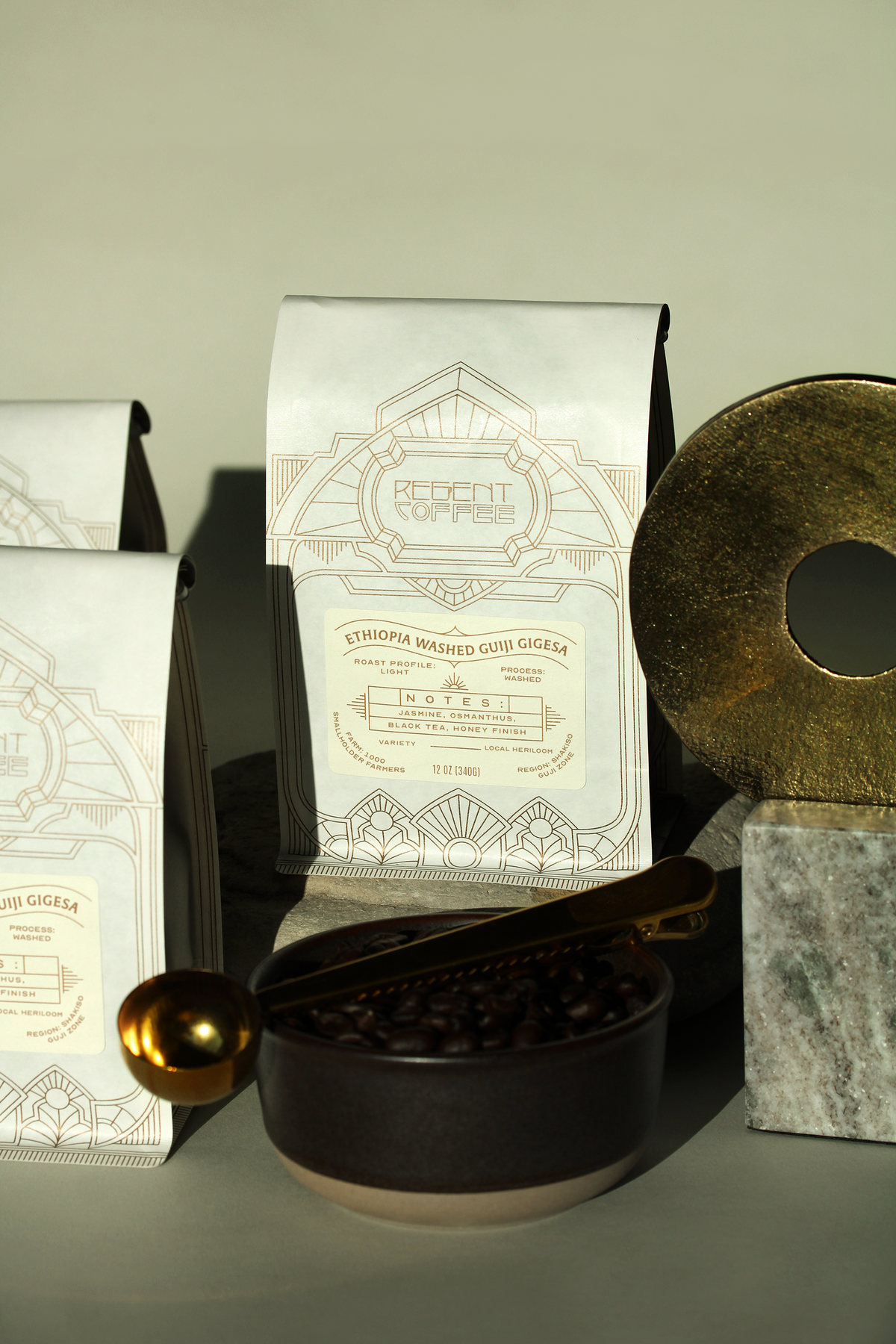 12oz bag of Ethiopia Washed Guji Gigesa between a gold statue, a bowl of beans and other bags