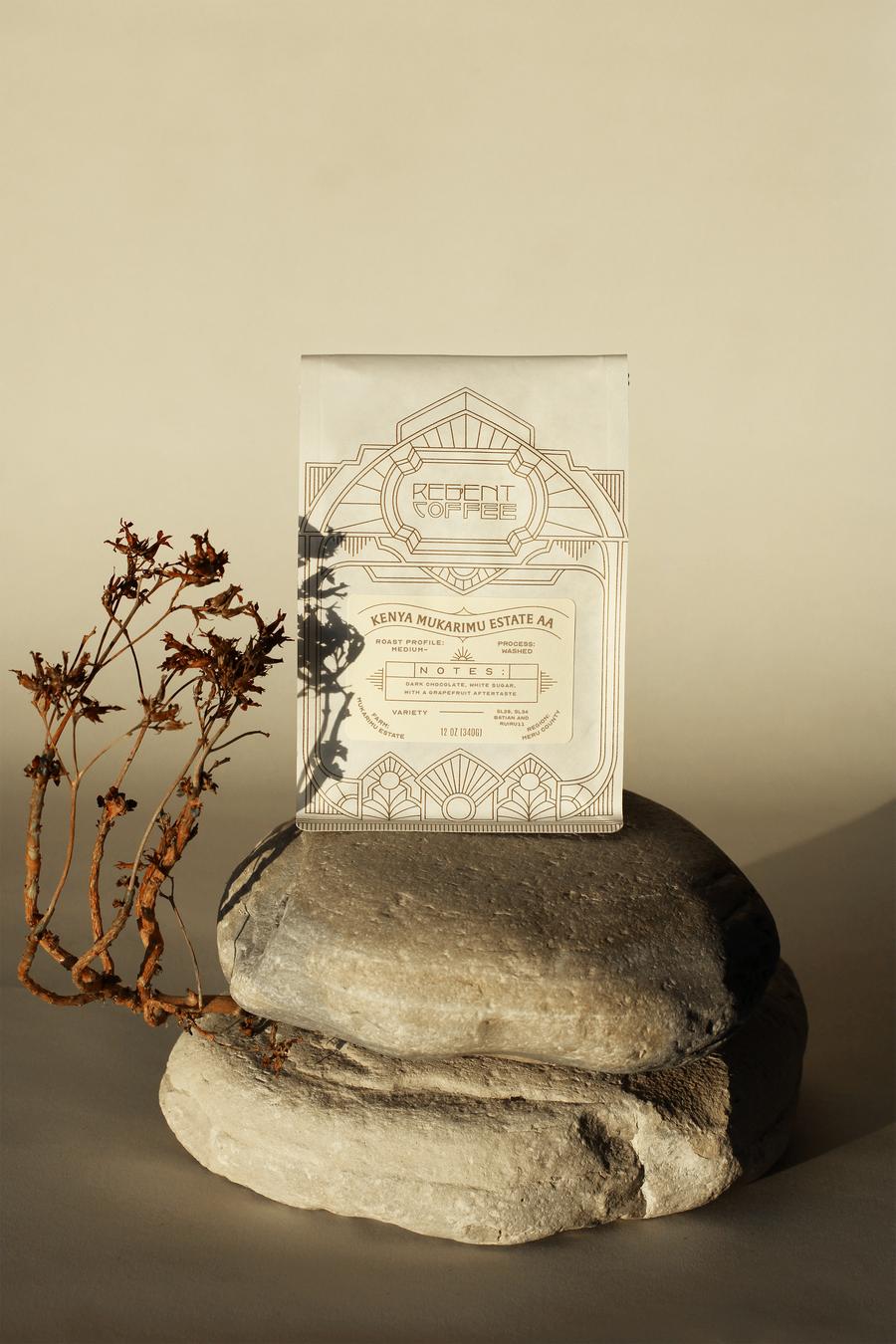 12oz bag of Kenya Mukarimu Estate AA sitting on a shaded rock