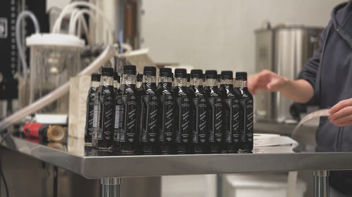 video of putting on stickers on glass bottles