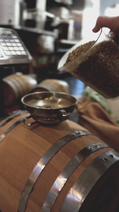 Video of filling green coffee beans to a oak barrel